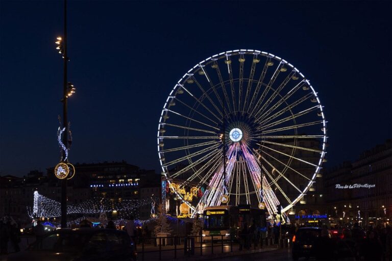 La grande roue illuminée et les décors lumineux du marché de Noël sur le Vieux-Port de Marseille, la nuit