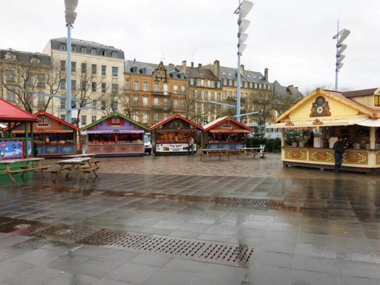 Chalets colorés du marché de Noël sur une place du centre de Metz, par temps de pluie