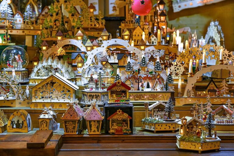 Étal de décorations de Noël en bois éclairées : arches à bougies, pyramides et petites maisons
